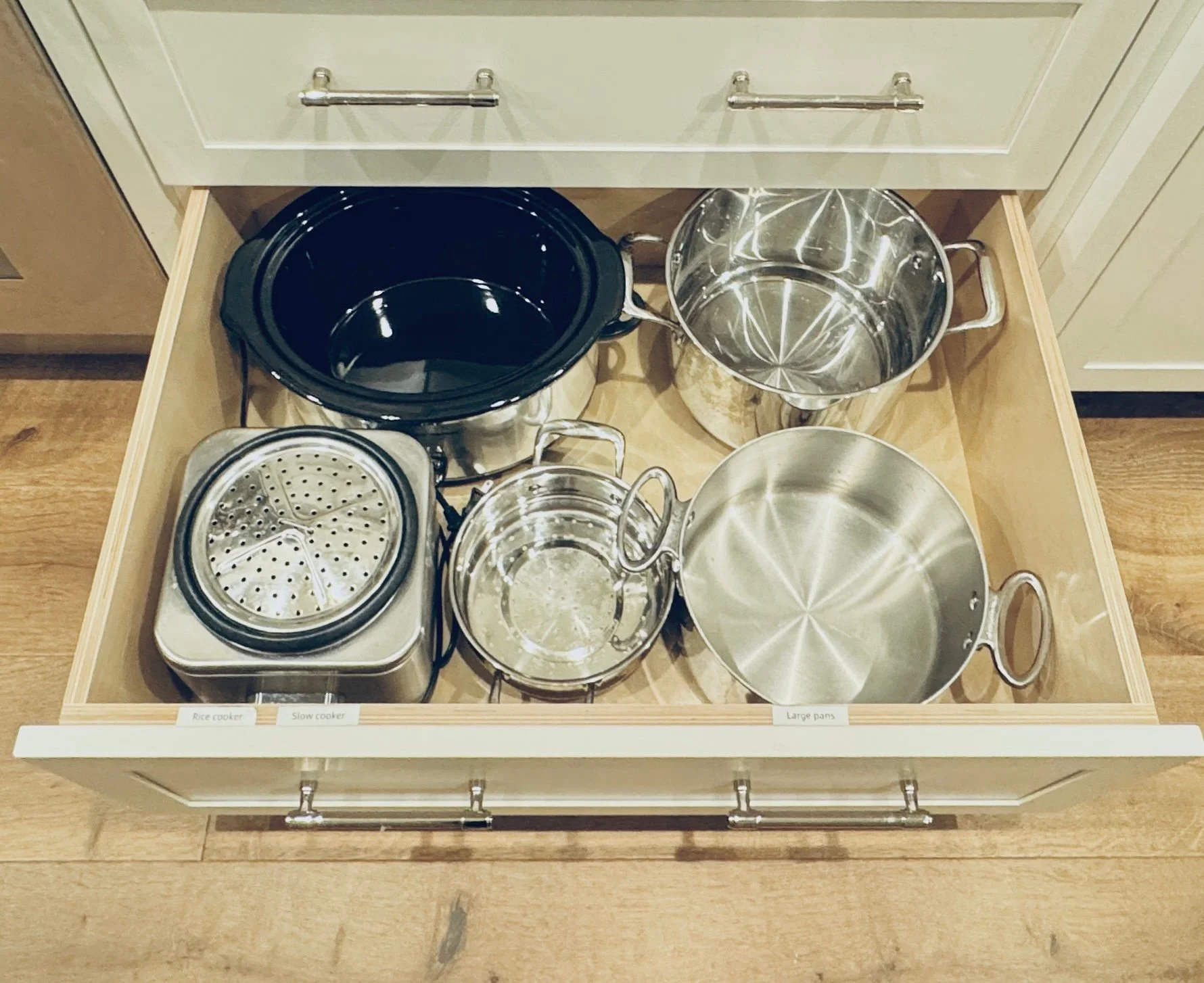 Deep kitchen drawer organization featuring stacked pots, nesting strainers, and streamlined cookware storage solutions in Park City, Utah.