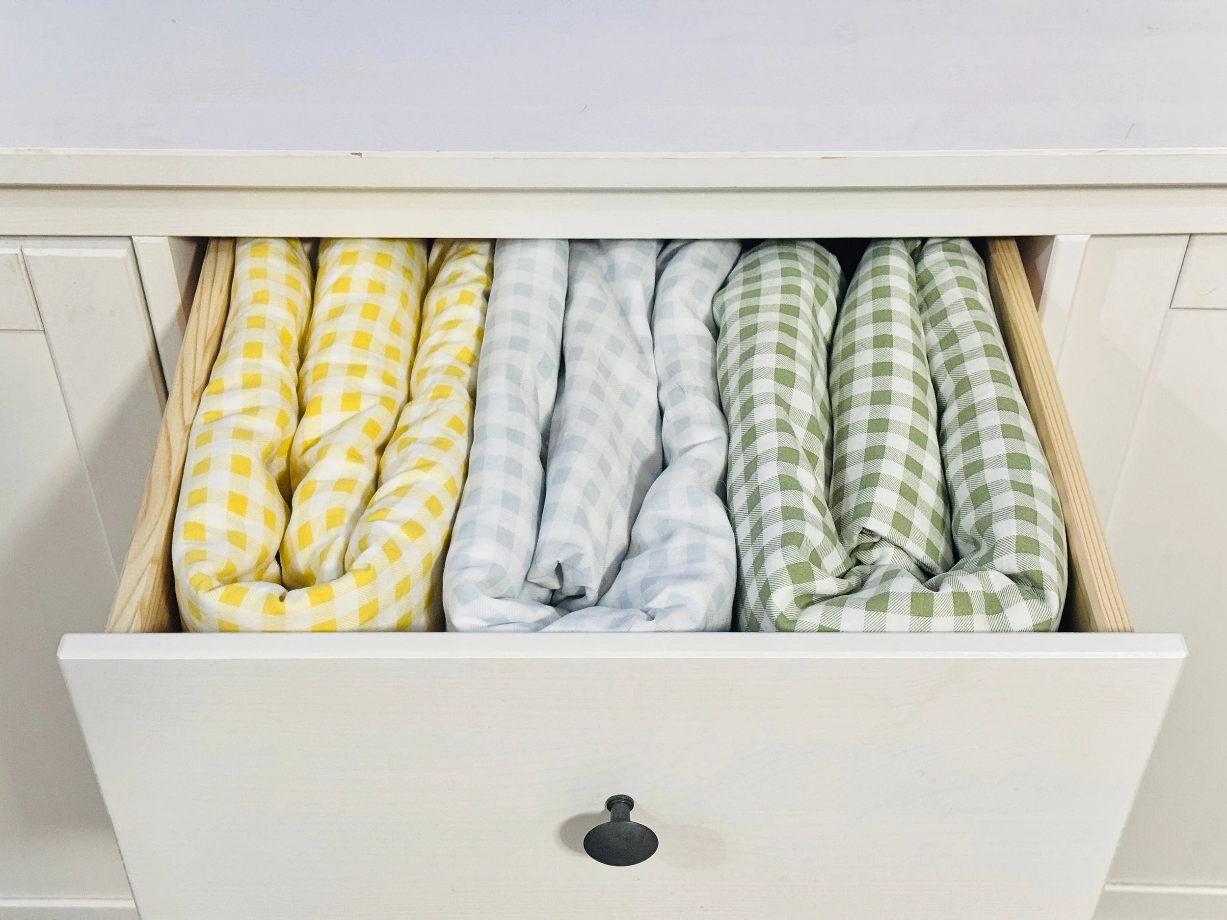 Pristine linen closet drawer organization featuring neatly folded duvet covers and bedding sets in Park City, Utah.