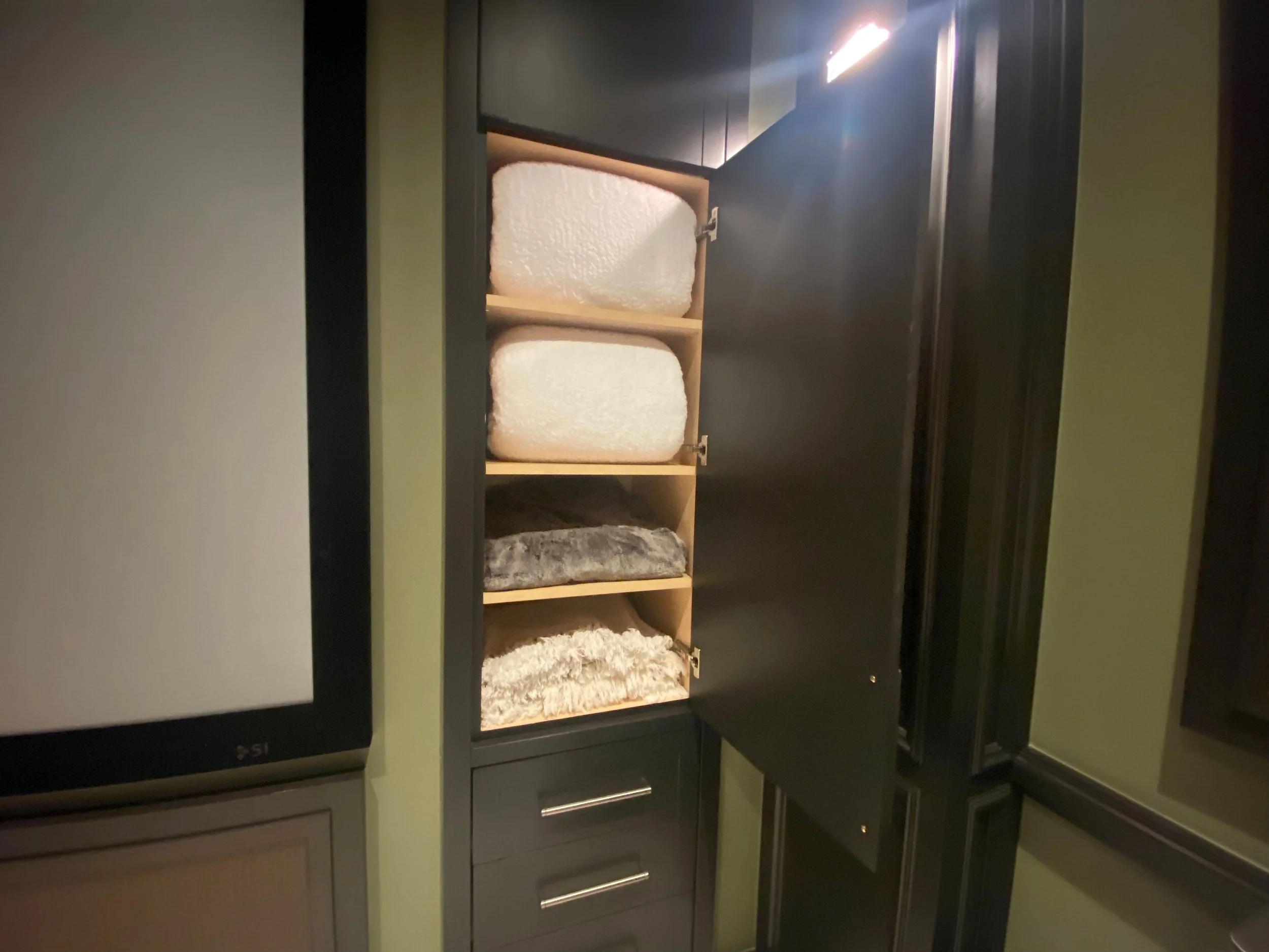Organized utility cabinet featuring neatly stacked household blankets in Park City, Utah.
