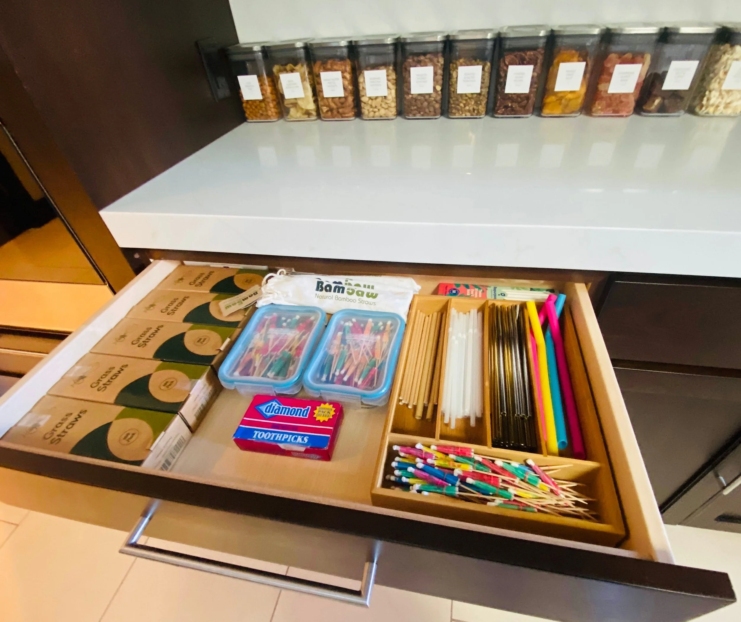 Organized entertaining drawer and kitchen counter featuring custom labeled snack bins, party supplies, and straw storage in Park City, Utah.