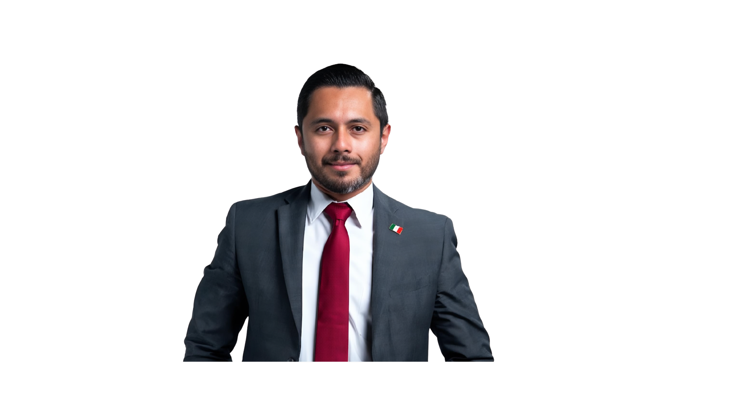 Hombre joven con barba y cabello oscuro peinado hacia atrás, vestido con traje gris, camisa blanca, corbata roja y un pin de la bandera de México en el saco, sonriendo ligeramente.