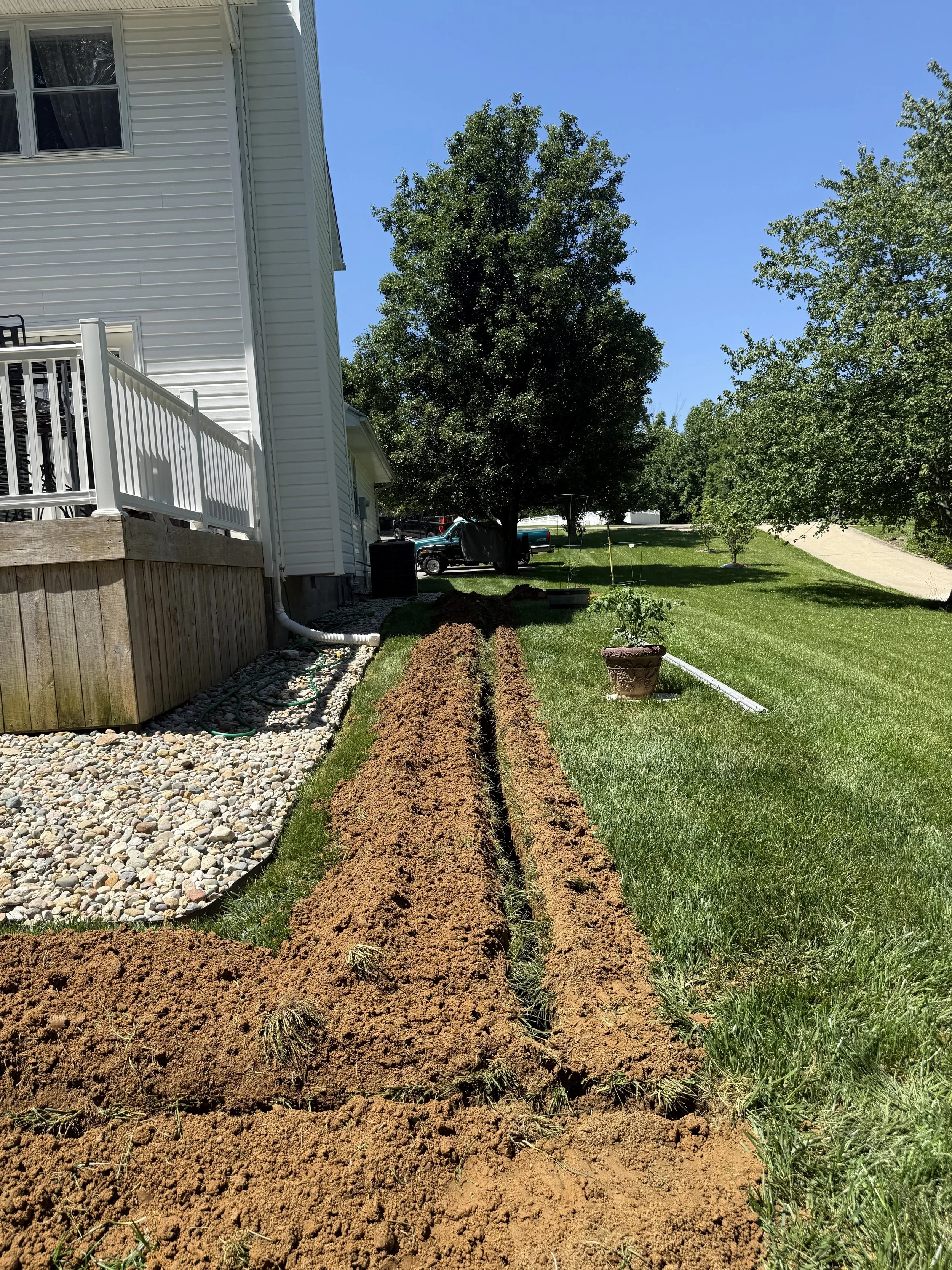 Exterior underground electrical line layout, conduit trenching, and main service pipe installation by ProVolt Electric in Southern Indiana.