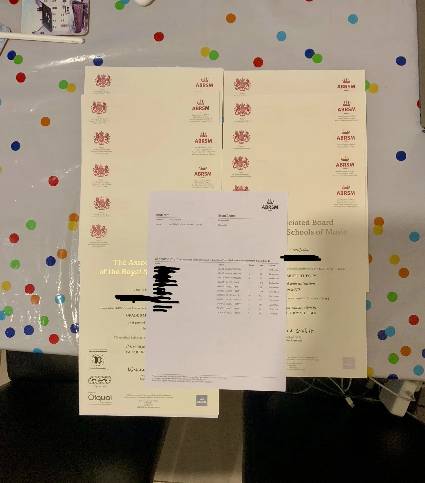 Lots of certificates proudly showing distinction grades
