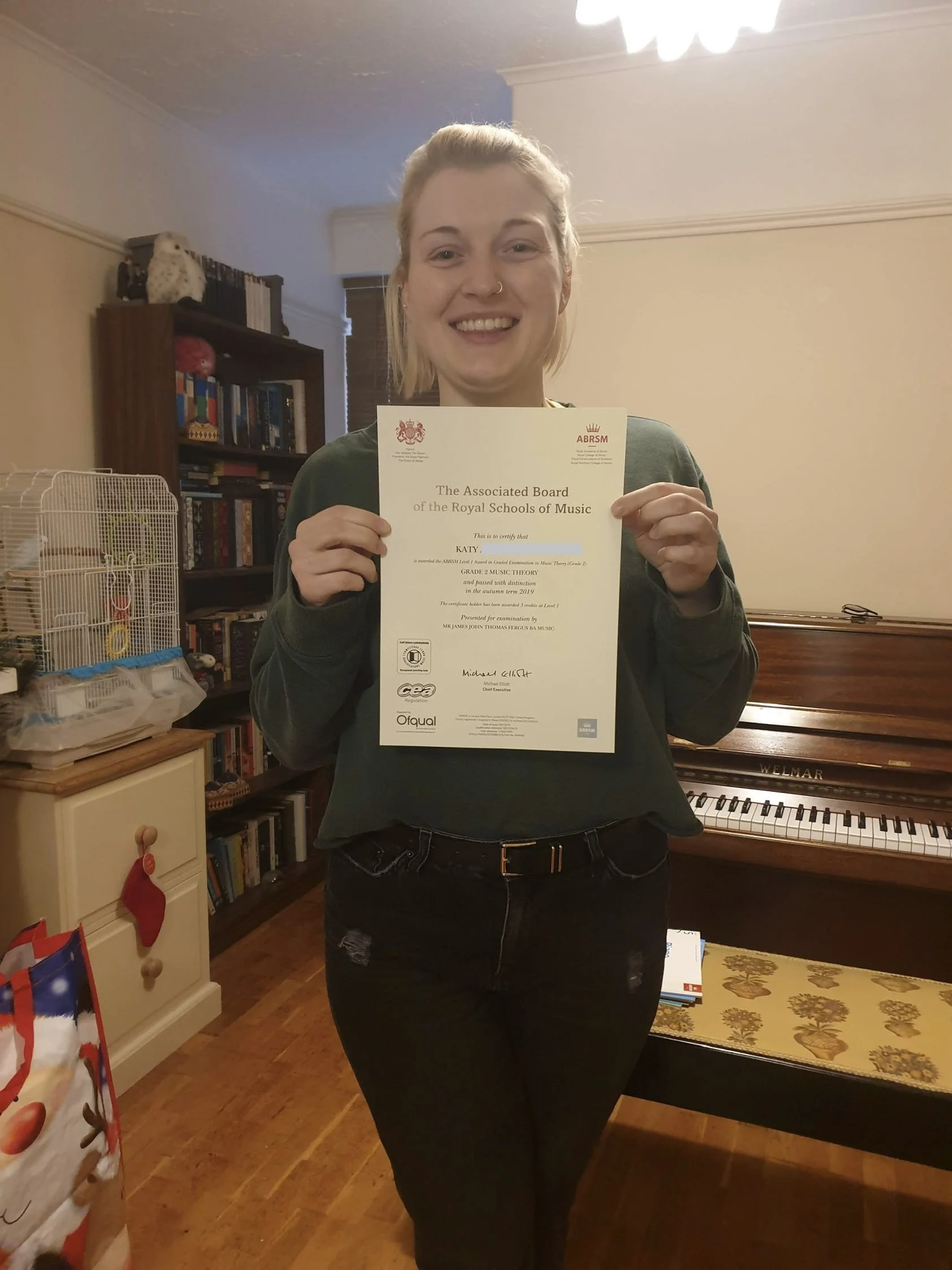 A woman proudly showing her music certificate