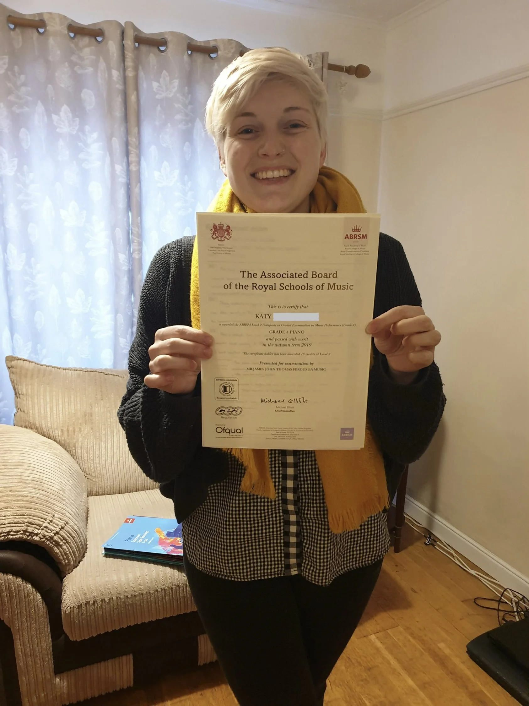 A person proudly showing their music certificate