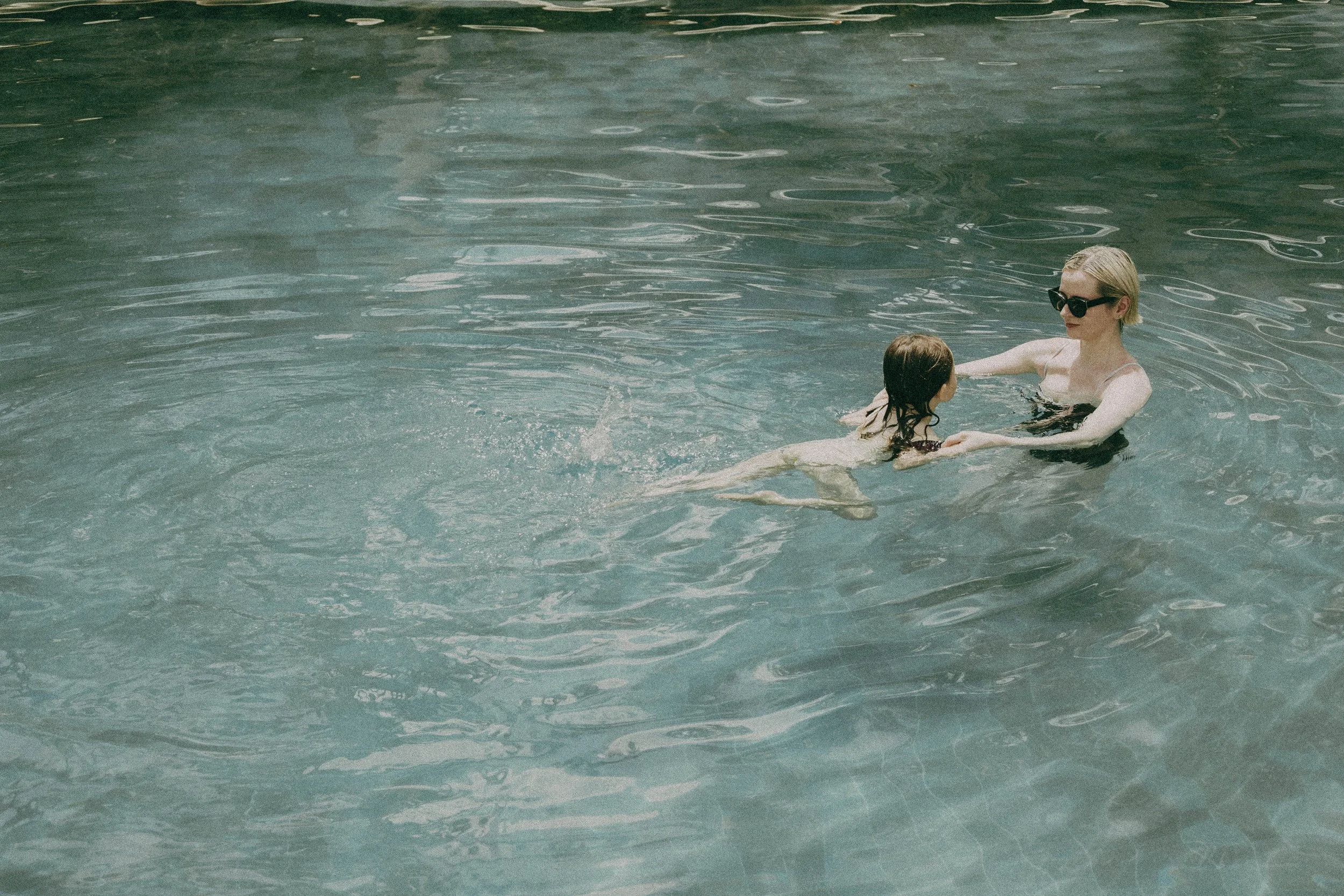 mother and baby in luxury pool at the boutique hotel