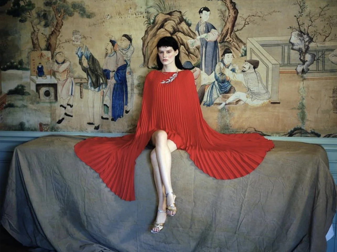 fashion model photographed in Paris, wearing red dress and luxury jewelery