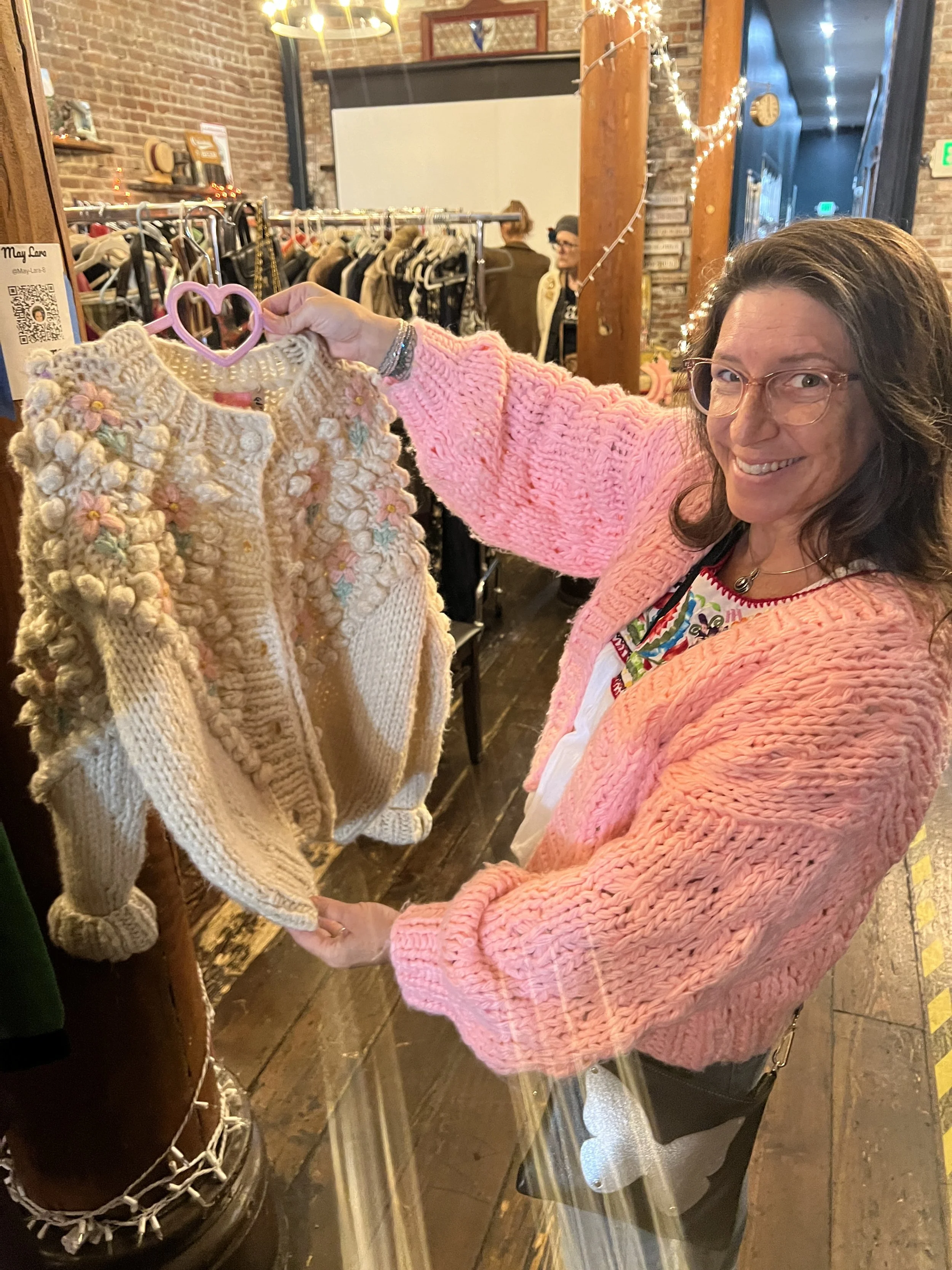 A vendor shows off a fun sweater