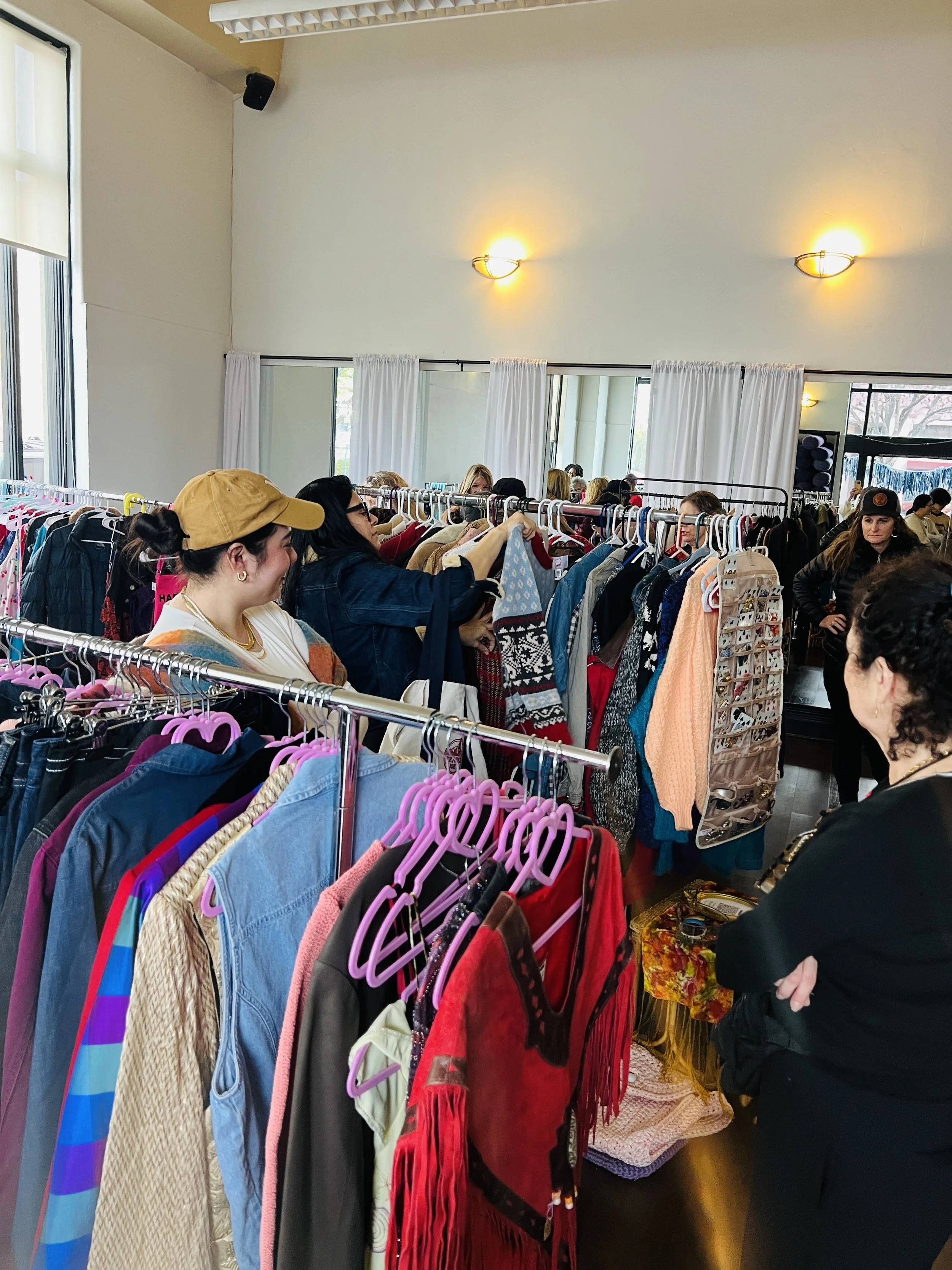 many shoppers browse racks of clothing