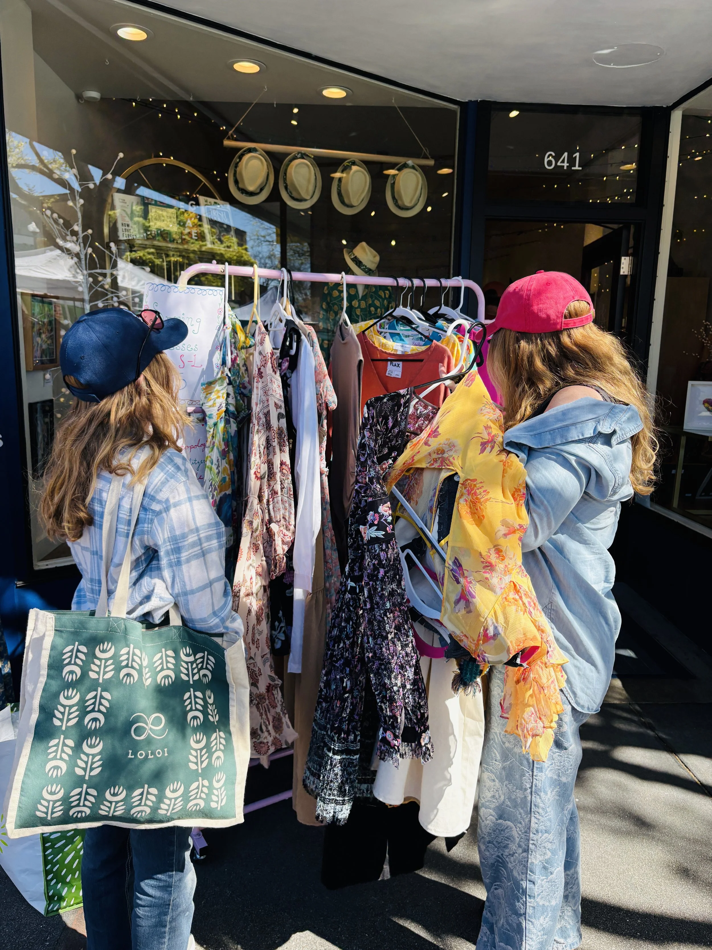 Shoppers browse a rack of second-hand fashion