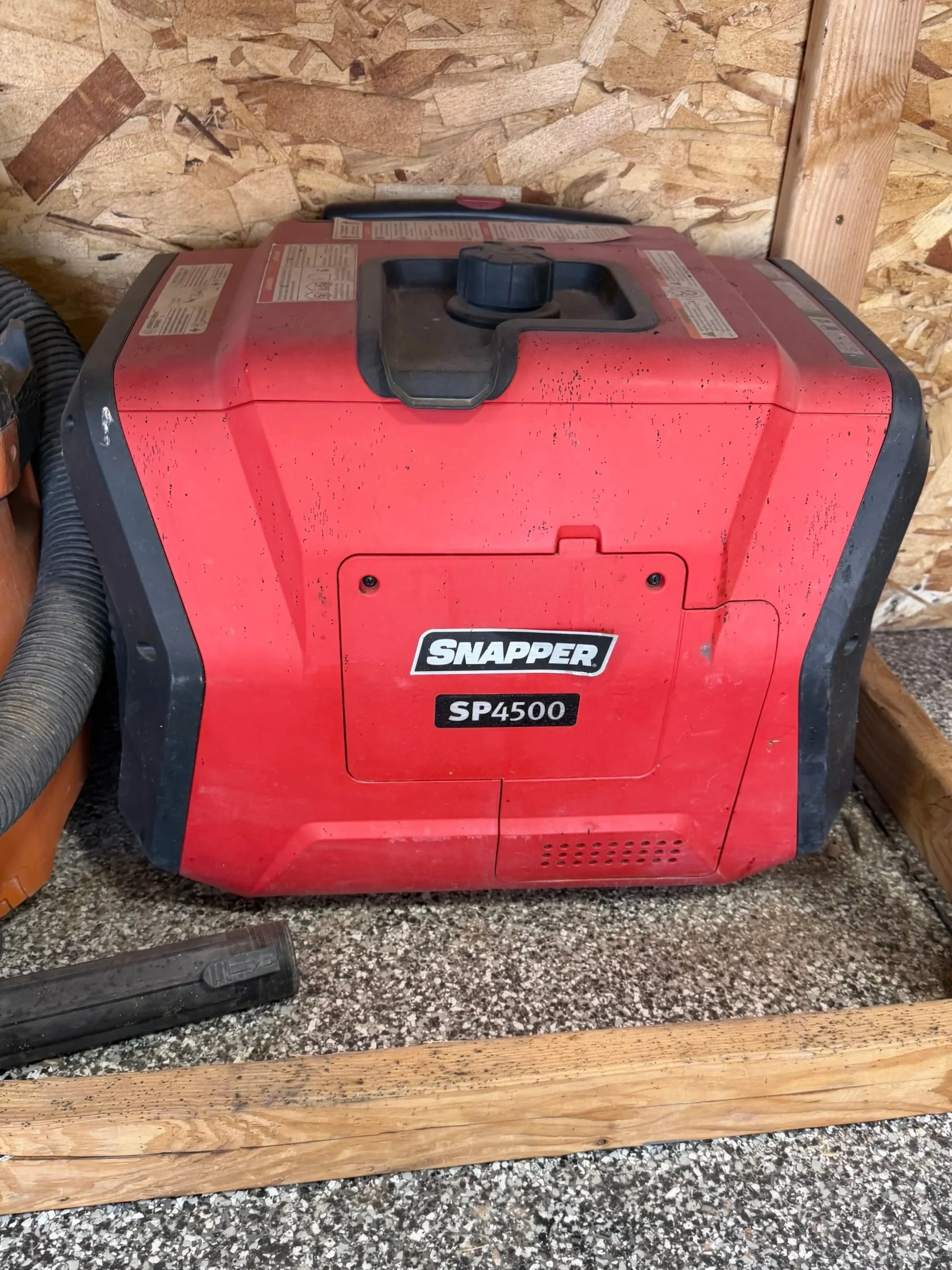 Red Snapper SP4500 portable heater in a workshop setting with wooden framing and dual hoses.