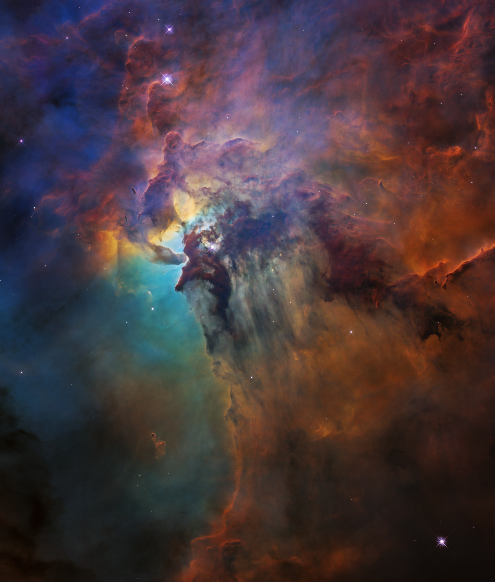 An image of the Carina nebula showcasing colorful clouds of gas and dust in space with bright stars scattered throughout.