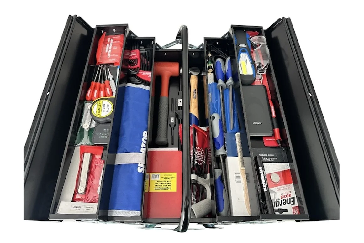 A well-organized toolbox drawer filled with various hand tools and equipment, including screwdrivers, pliers, a hammer, a wrench, and other utility tools.