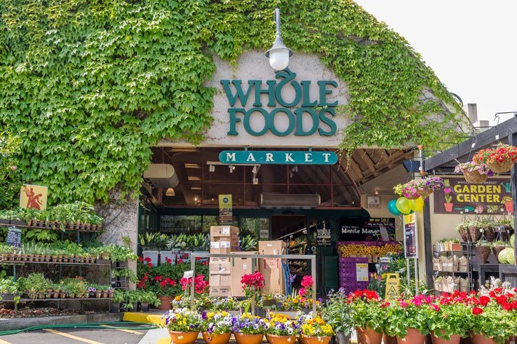 Exterior view of Whole Foods Market with plants and flowers for sale outside