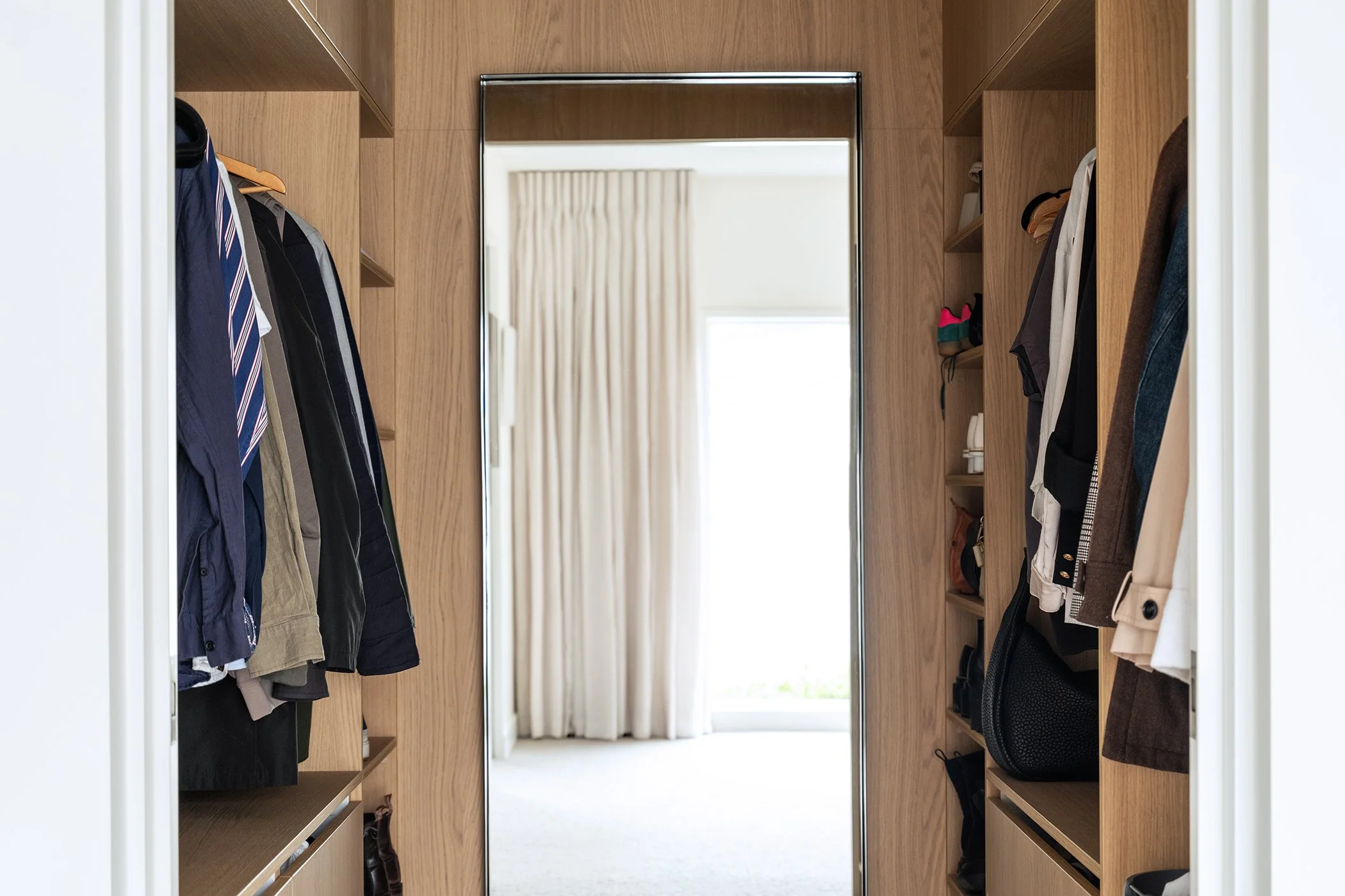 Modern residential interior design featuring custom walk-in wardrobe