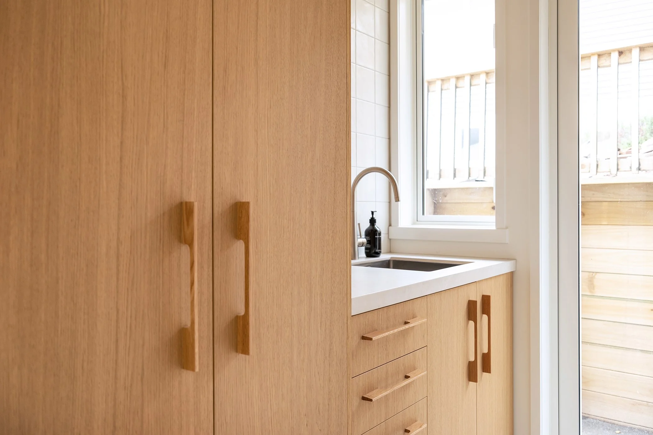 Modern residential interior design featuring light oak veneer laundry