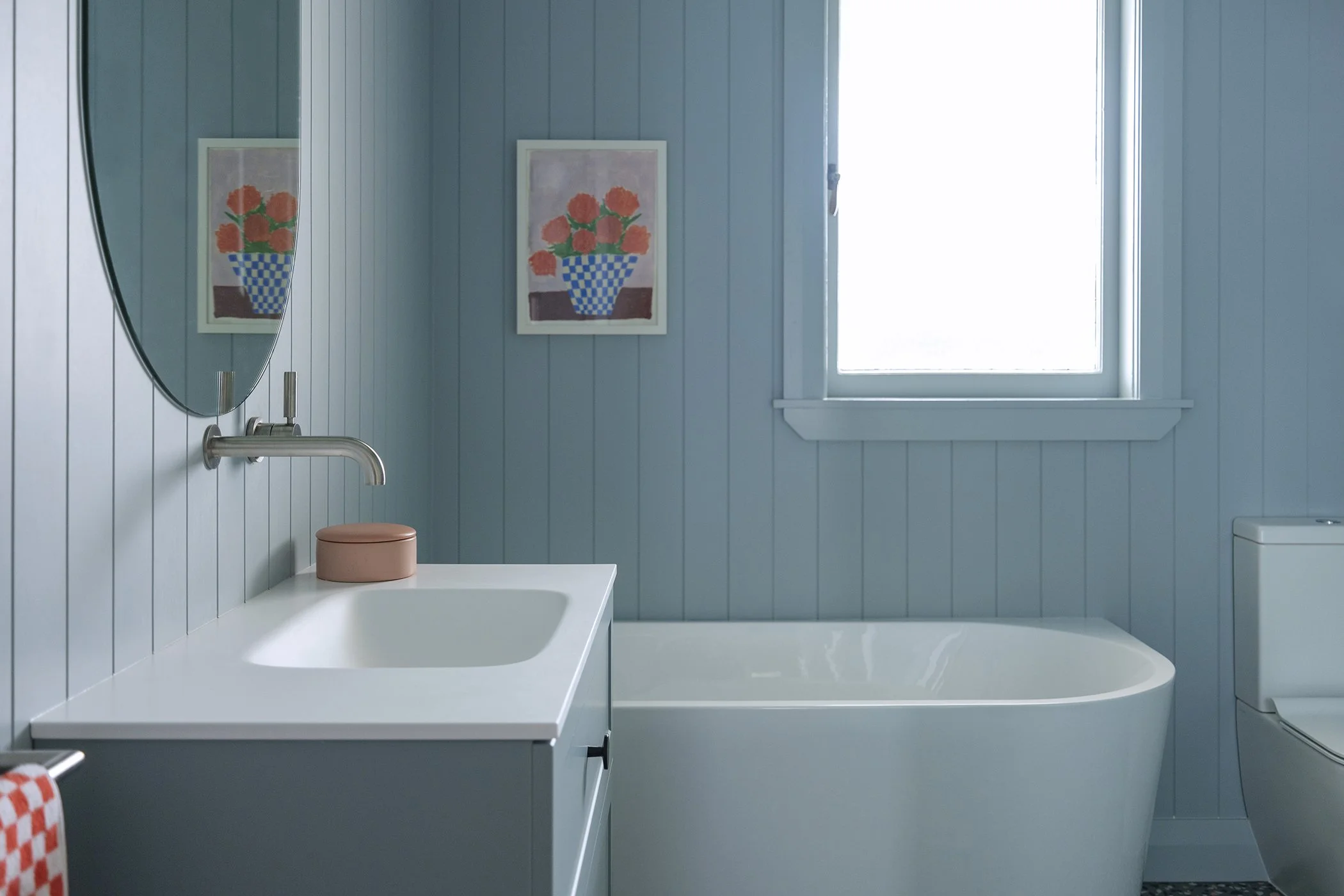 Modern residential interior design featuring a v-groove lined bathroom colour washed in blue