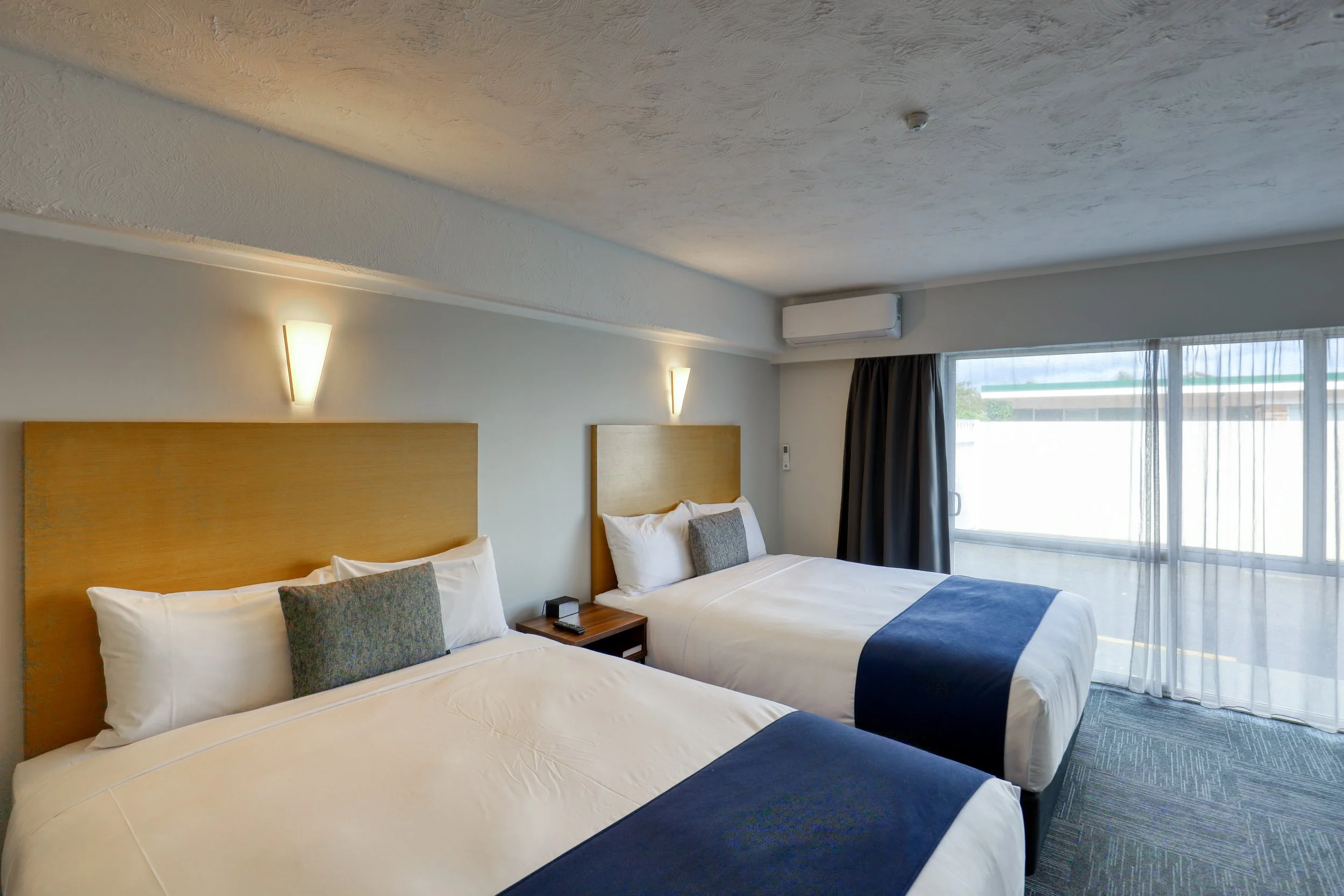 Two queen beds in a spacious guest room at Park Central Rotorua.