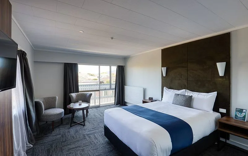Two Bedroom Suite with king bed and seating area at Park Central Rotorua.