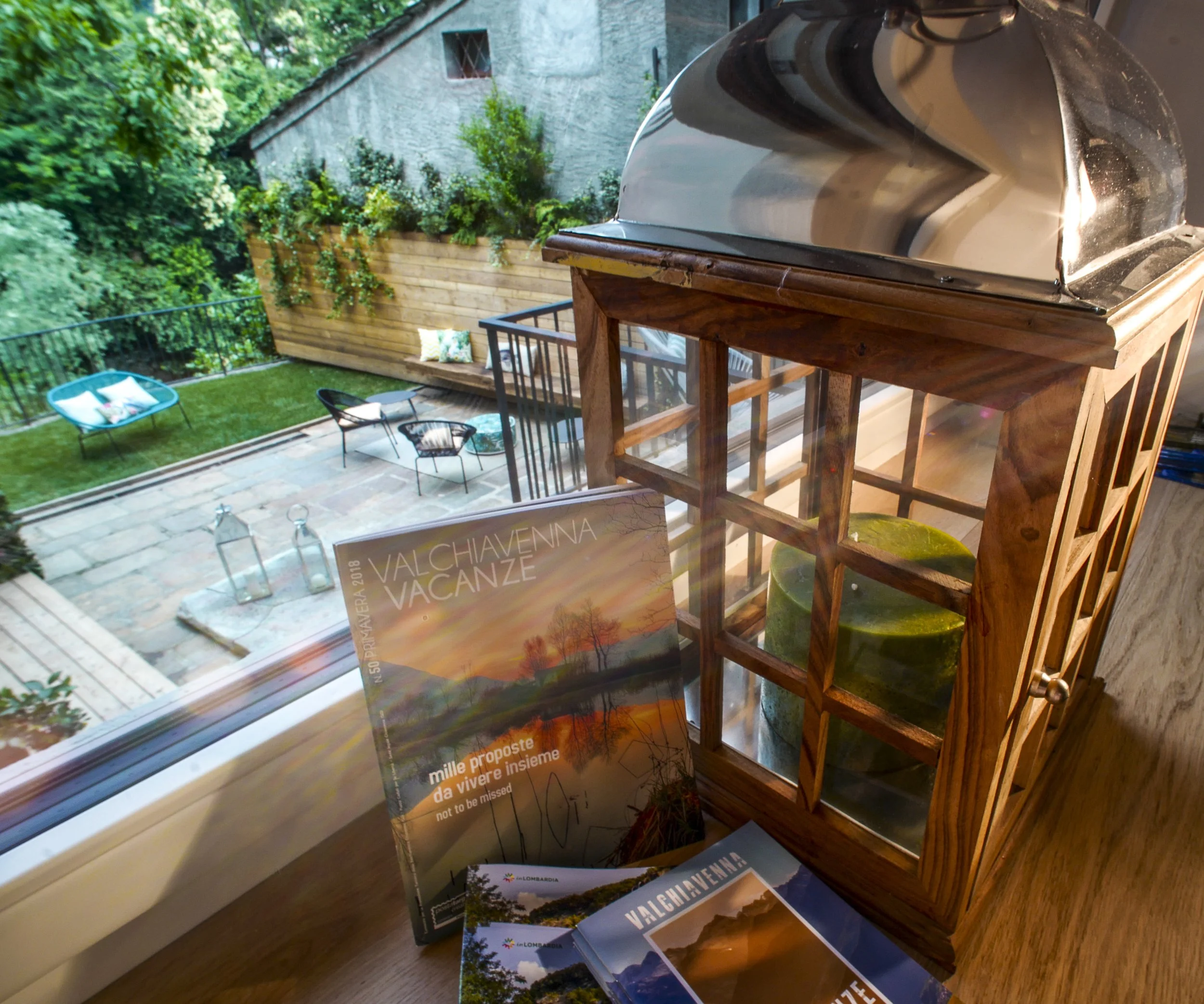 Private garden and outdoor relaxation area at Palazzo Giani, overlooking the Mera River in the heart of Chiavenna.