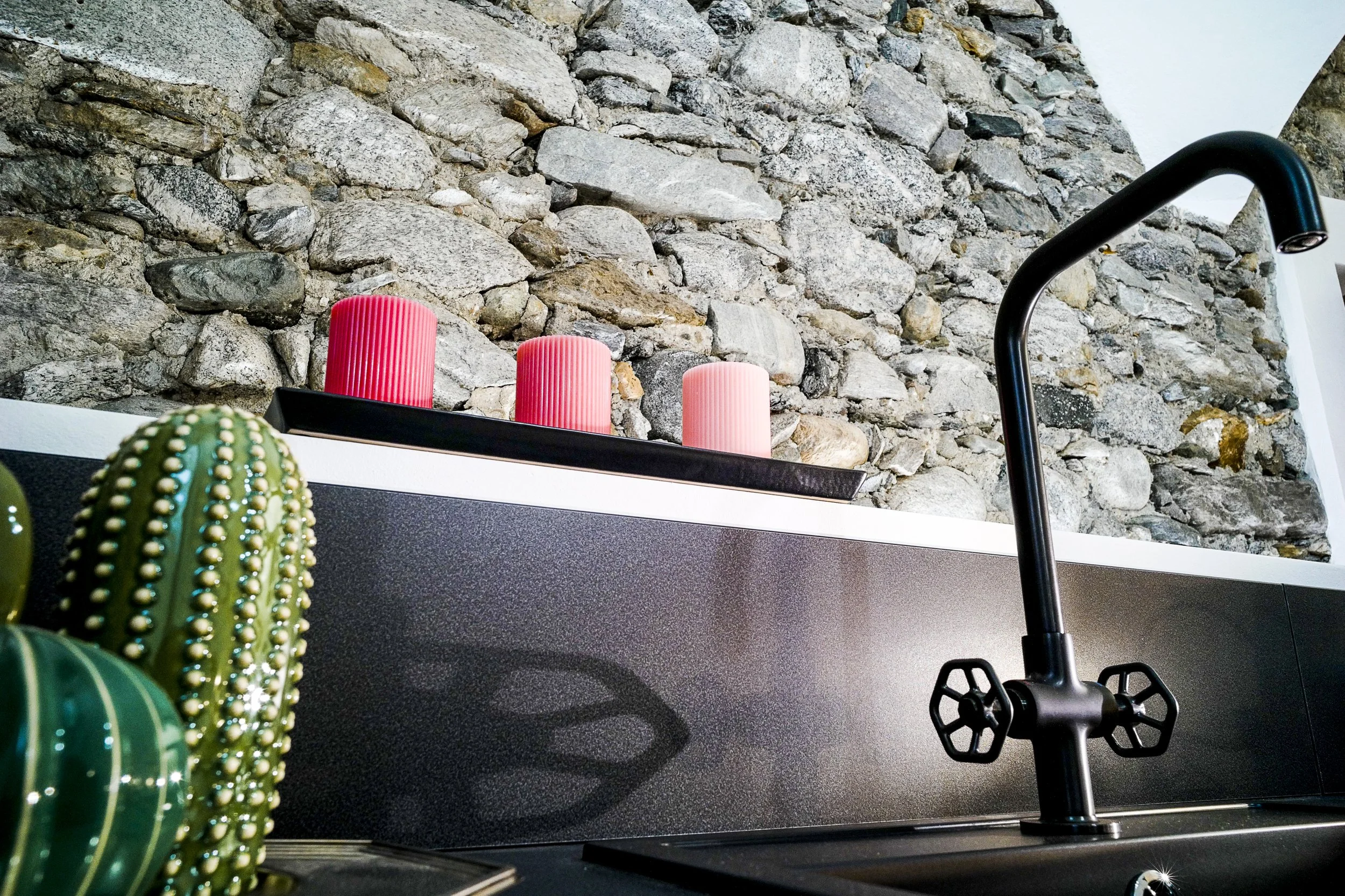 Fully equipped designer kitchen at Palazzo Giani with stone walls and premium amenities in Chiavenna.