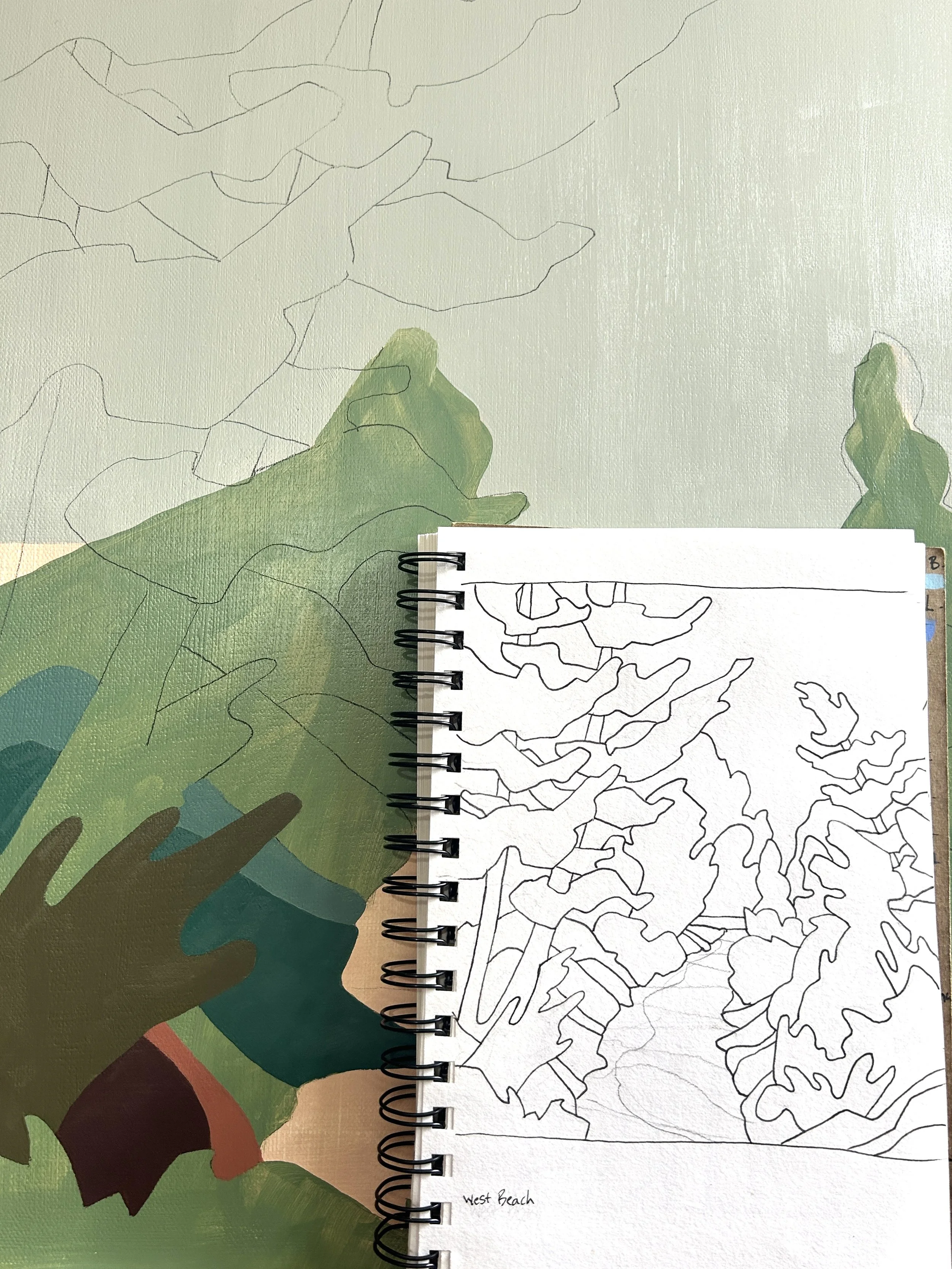 A sketch of the West Beach area with an outline of local terrain and vegetation, overlaid on a colorful map background. The sketch is on a spiral-bound notebook page.