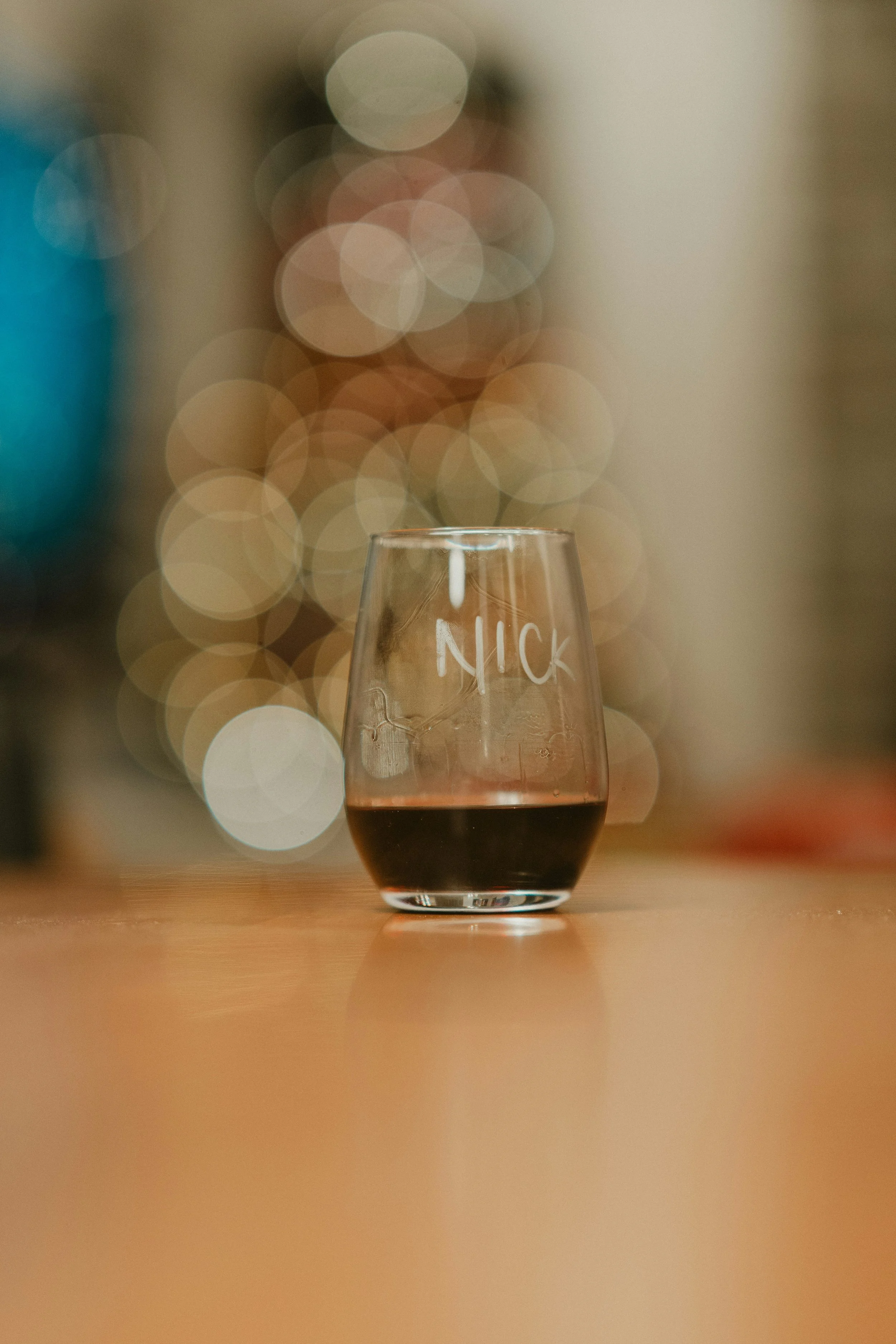 A glass of red wine with glass engraving