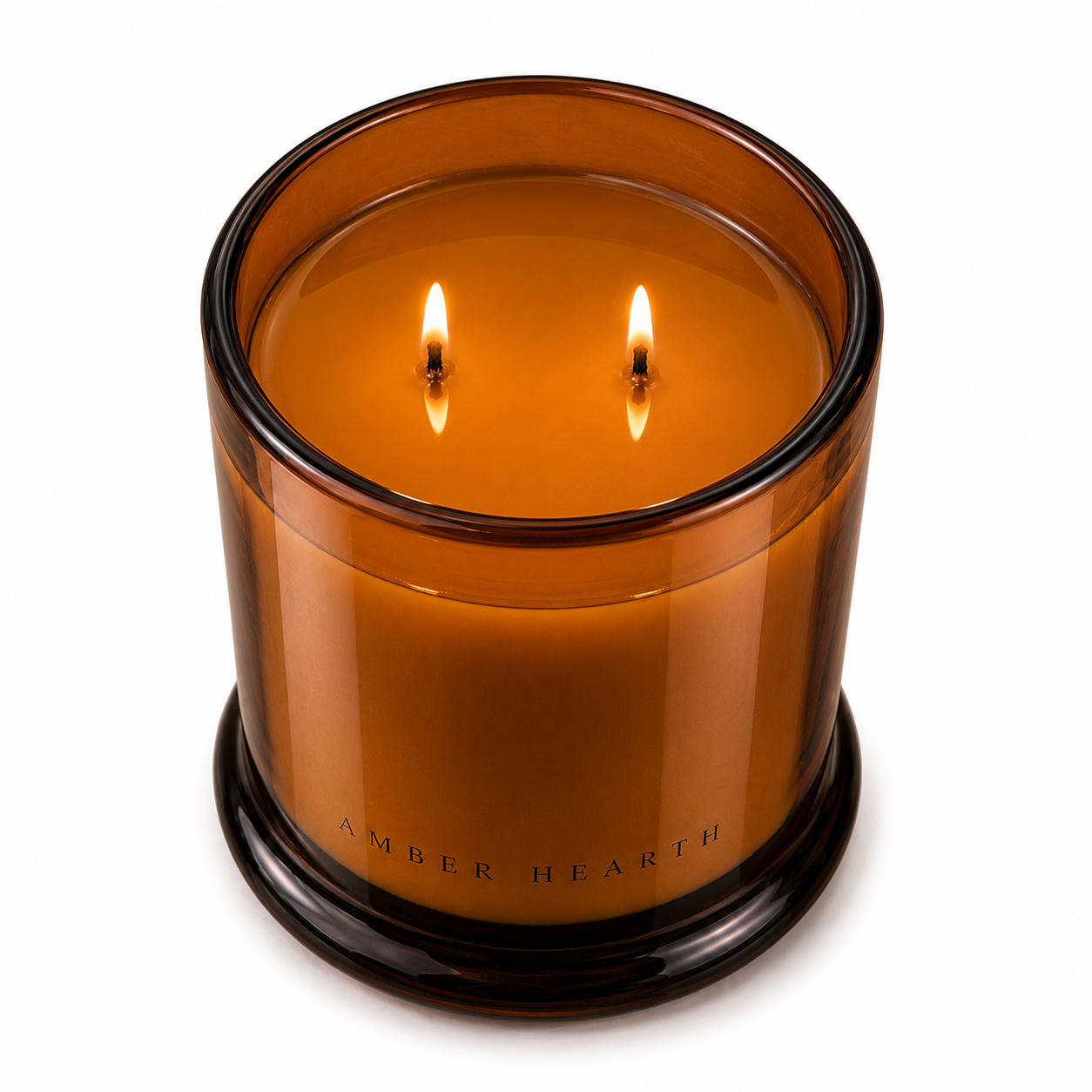 An amber-colored glass candle holder with a lit two-wick candle inside, labeled 'Amber Hearth'.