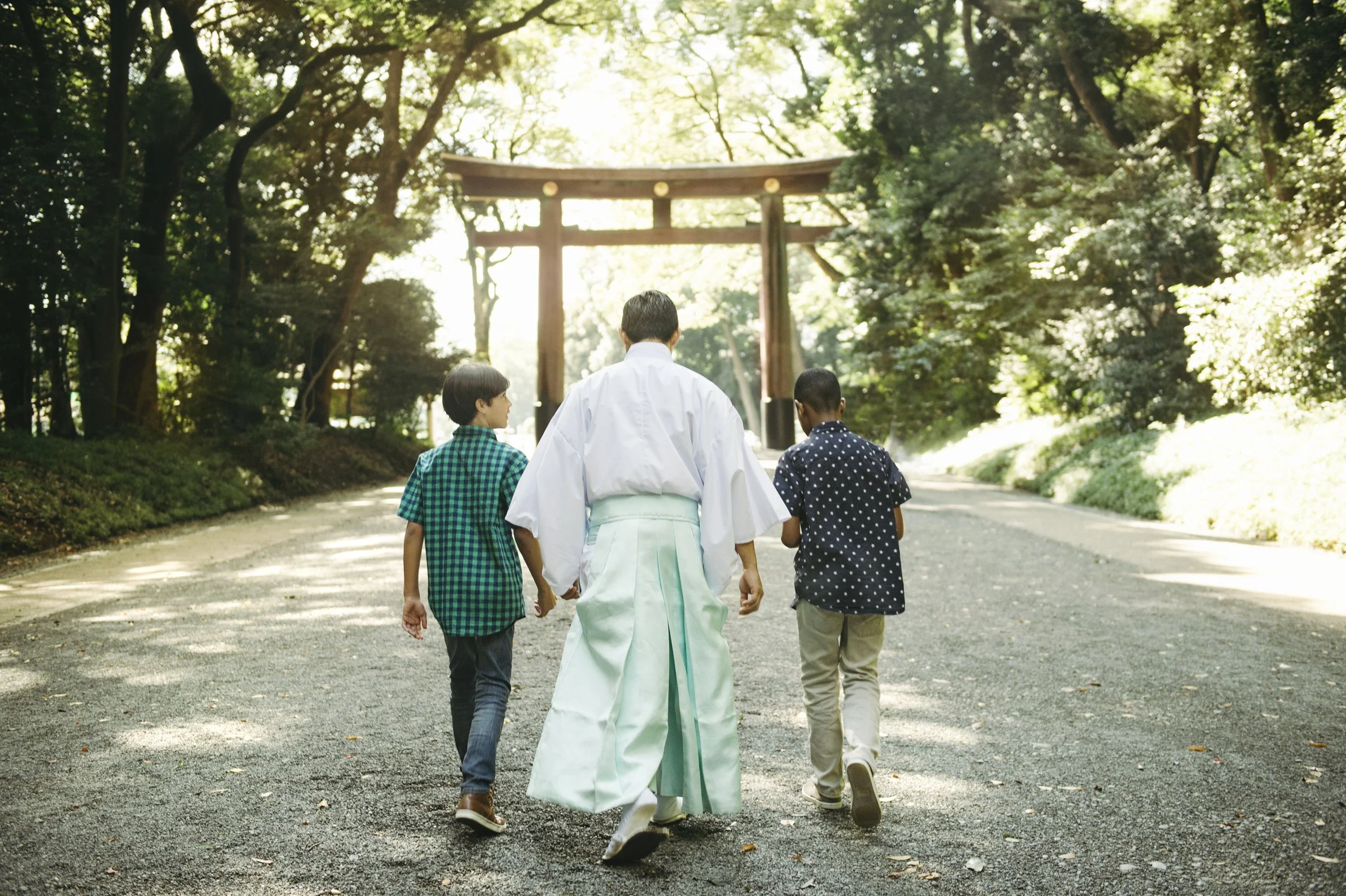 Boys walking in Japan with woman in traditional clothing during Adventures by Disney