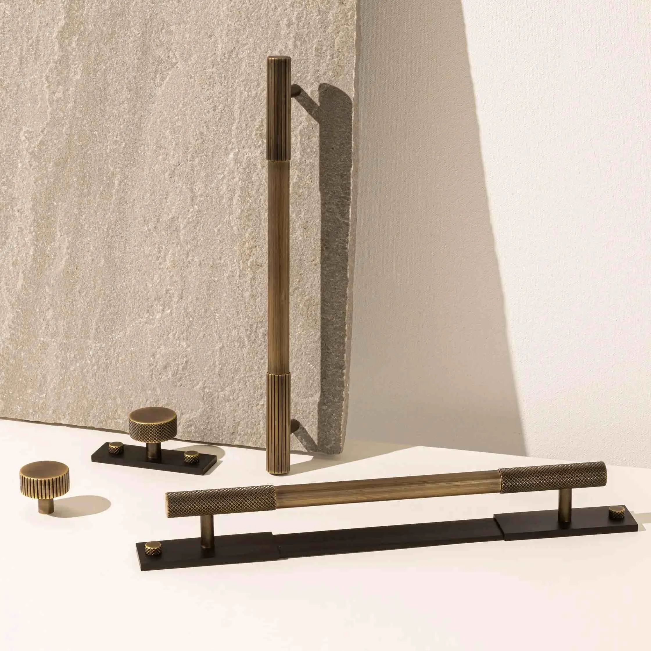 Decorative objects with textured surfaces displayed on a white surface against a light-colored background.