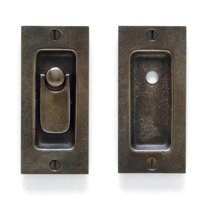 Two vintage dark metal wall plates, one with a toggled switch and the other empty