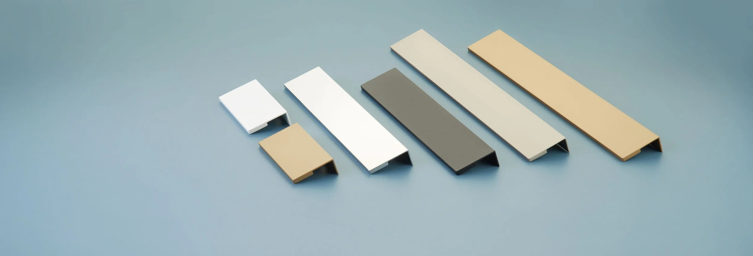 Seven color samples arranged in a row on a light blue background, ranging from white, beige, gray, to tan.