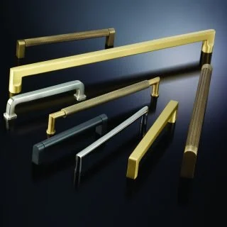 Collection of various metal and plastic drawer handles and pulls in different finishes and sizes