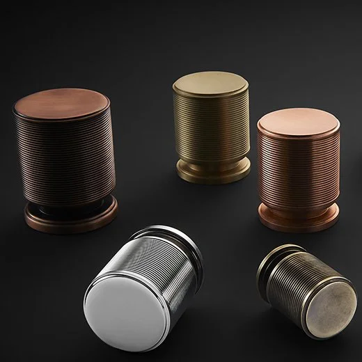 Five metallic cans in various colors and finishes on a black background.