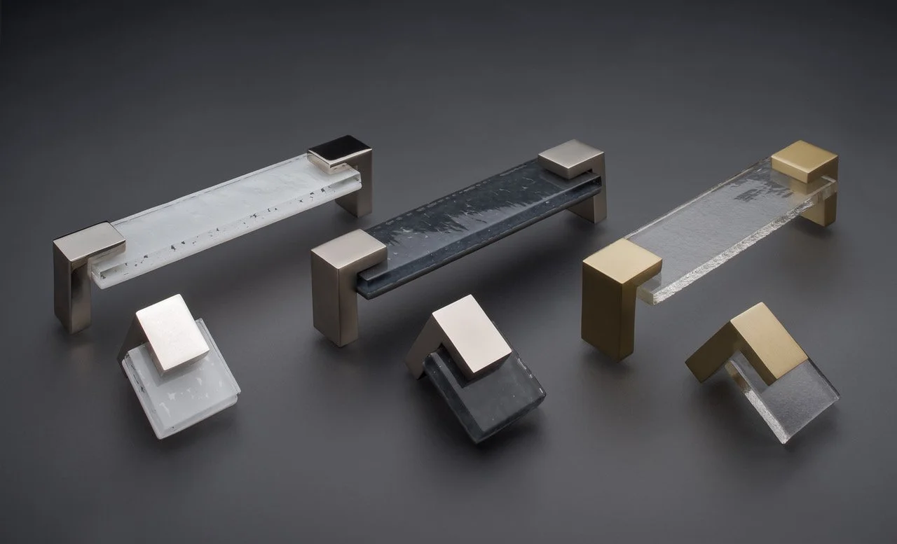 Various modern and abstract glass and metal door handles on a dark background