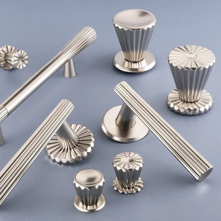 Collection of metallic, ribbed, rocket-shaped objects on a light blue surface.