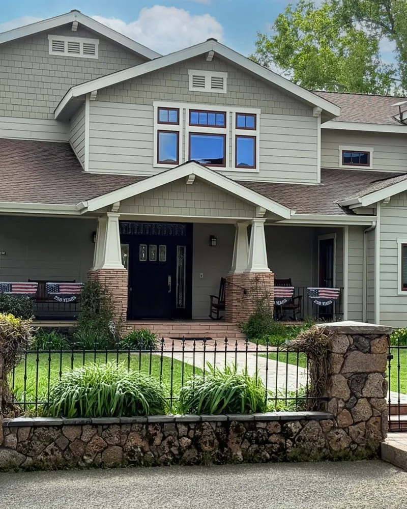 Front view of a gray residential house with a porch painted by local residential house painter Steven Francis Painting