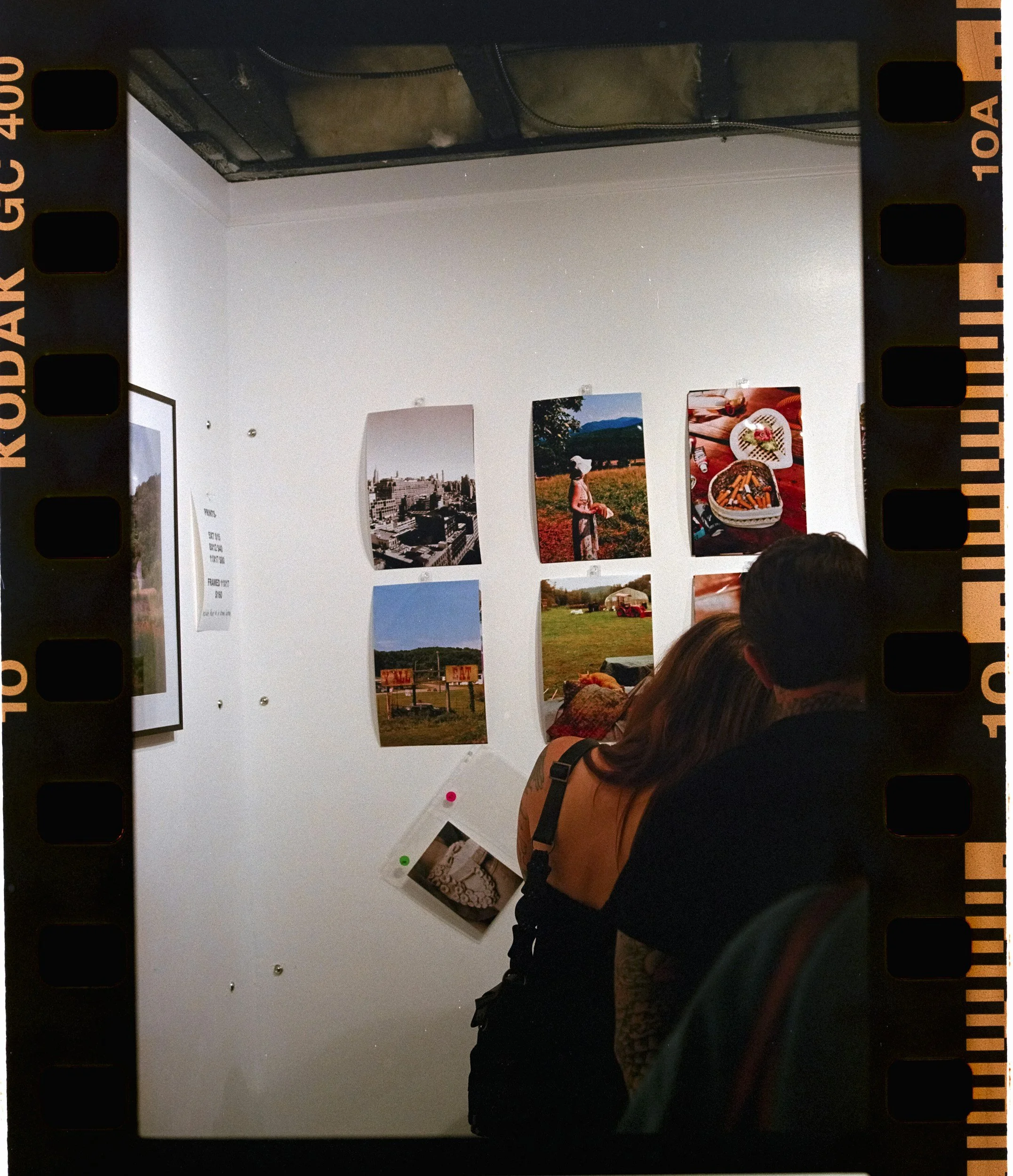 kodak film roll photo of couple in front of photo gallery