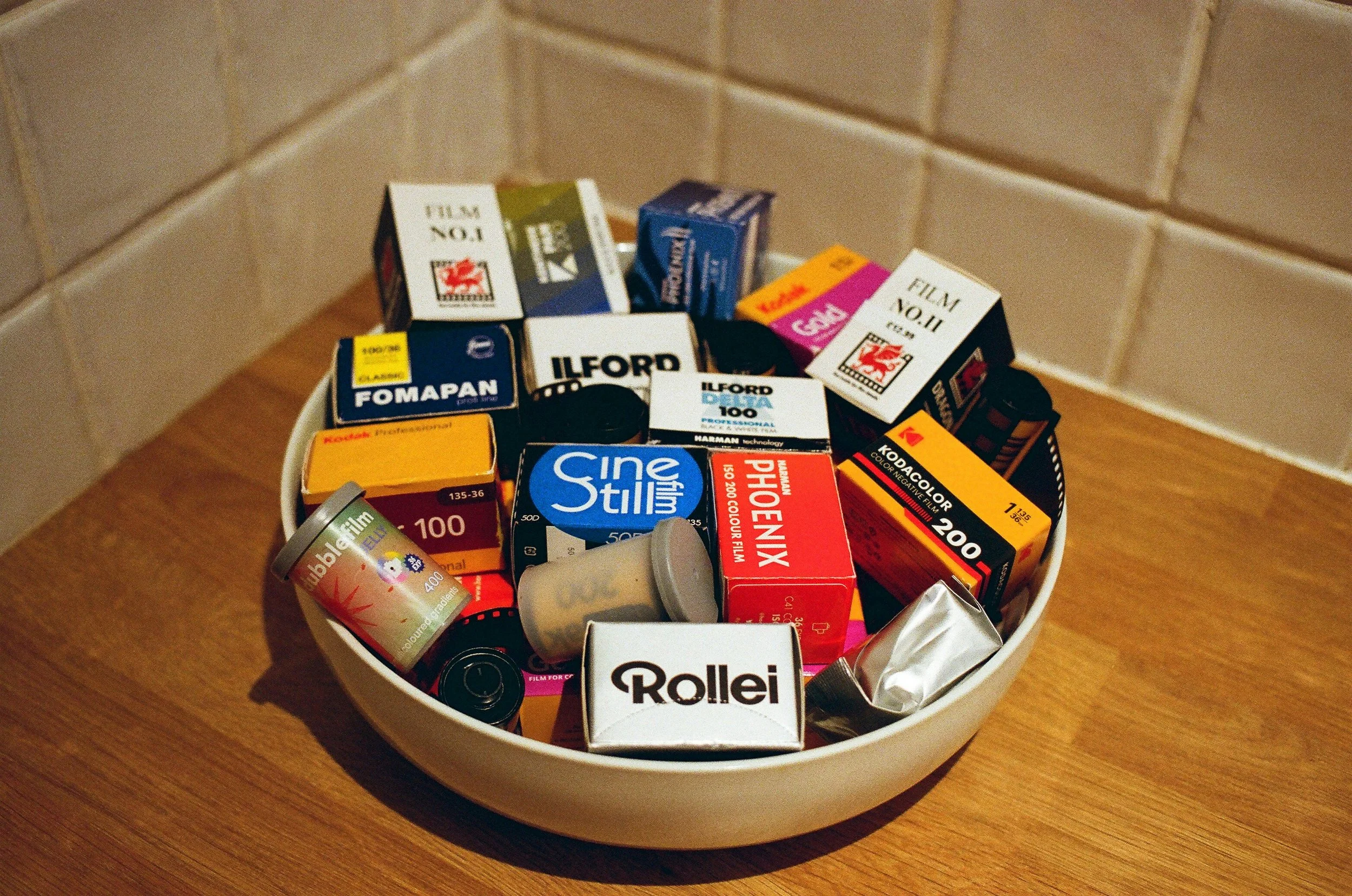 bowl of camera film rolls of all kinds of table