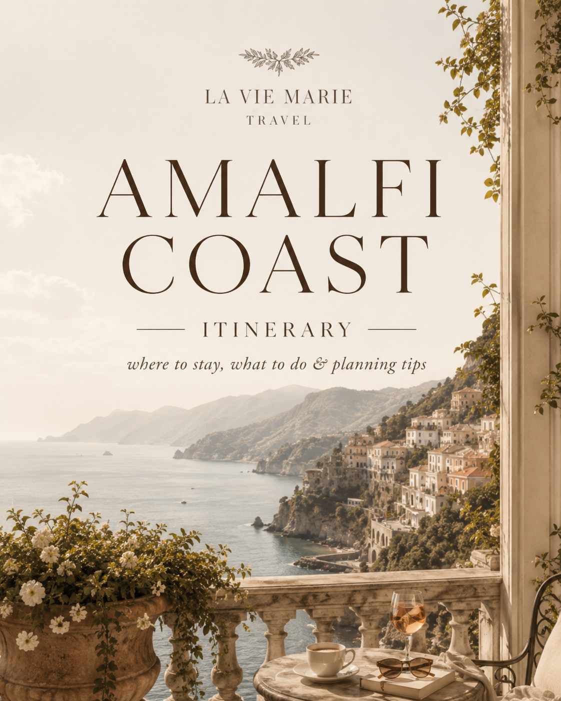Tourist brochure cover featuring a seaside view of Amalfi Coast with white buildings on cliffs, a small table with a coffee cup, sunglasses, a book, and a glass of rosé wine on a balcony.