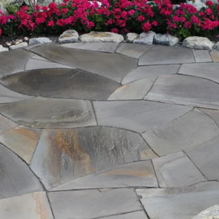 Organic stone pathway professionally installed by Rocky Creek Landscape and Design here in the Treasure Valley. This pathway is highlighted by pink flowers.