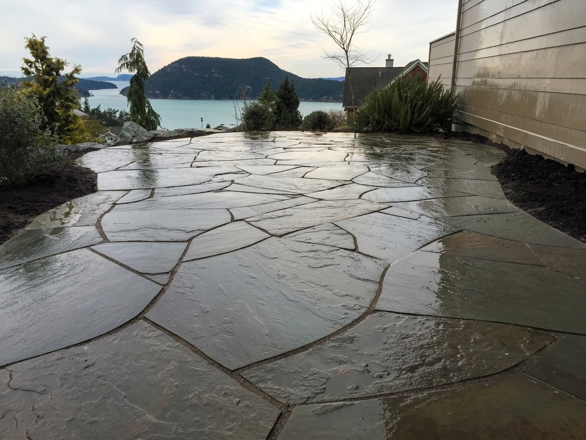 Wet stone pathway through lush Treasure Valley foliage, expertly installed by Rocky Creek Landscape & Design in Boise Idaho. Contact us for custom hardscapes.
