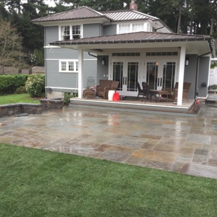 Rocky Creek Landscape & Design sample of work in Boise Idaho.Backyard patio with outdoor furniture and house in the background.