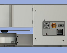 Close-up of a gray industrial machine with control panel and safety features