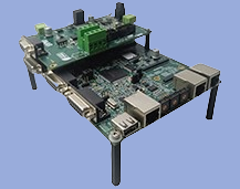 Single-board computer with green circuit board, multiple ports, and connectors, mounted on a metal frame with four black legs.