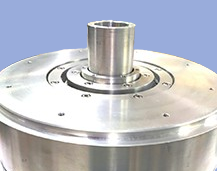 Close-up of a metallic industrial machine component with a cylindrical protrusion on a blue background.
