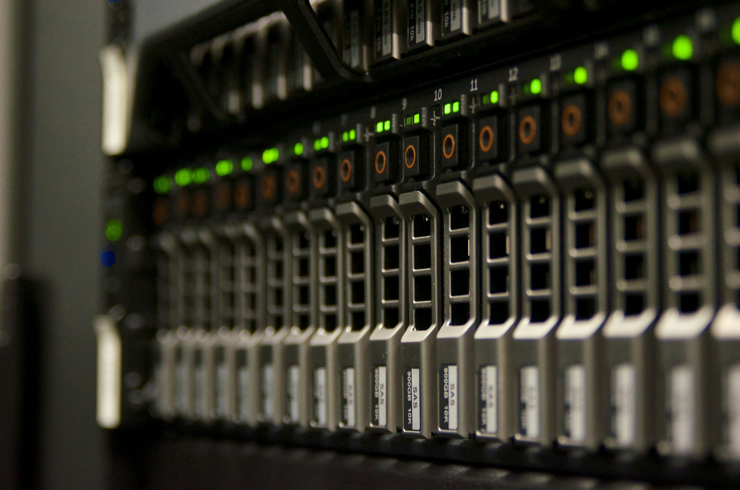 Close-up of a server rack with multiple computer modules, each with LED indicator lights showing activity.