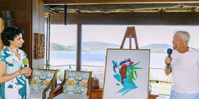 RBIJ CEO Maha Jweied presented artwork by death row exoneree Ndume Olatushani to Sir Richard Branson, now proudly displayed on Necker Island, BVI.