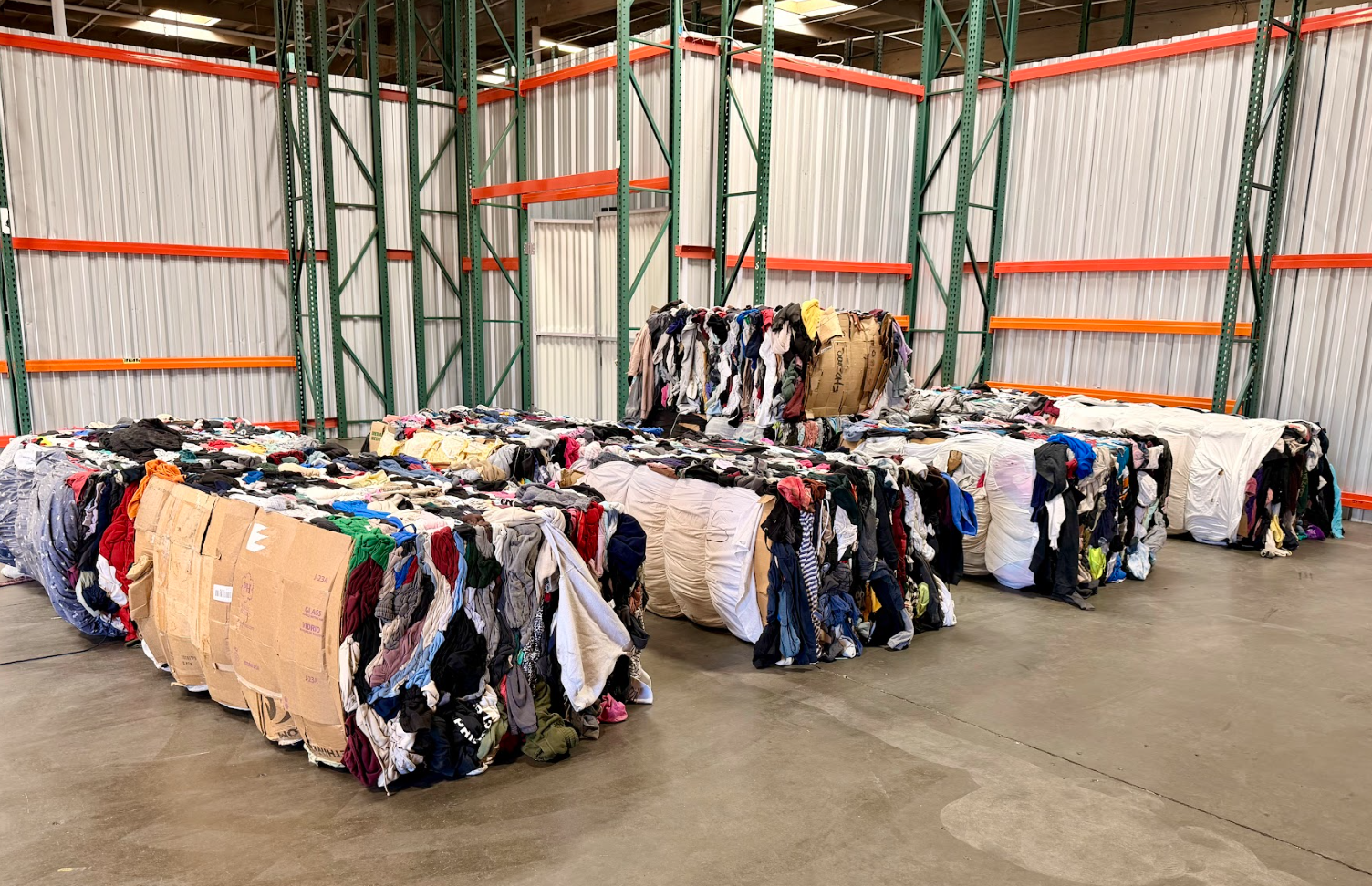 Wholesale used clothing inventory inside the OC Rag House warehouse.