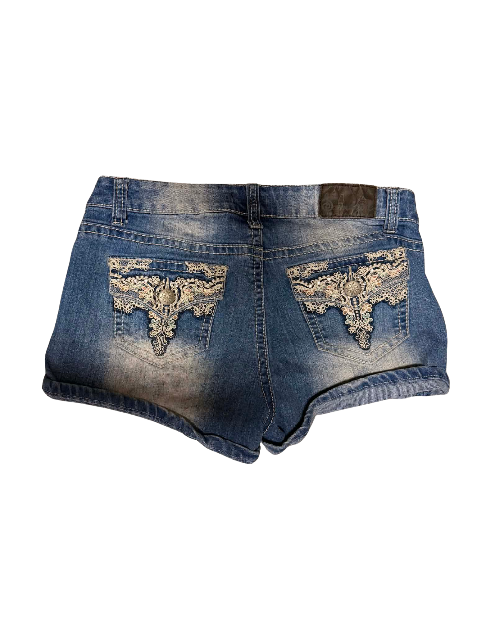 Women's Y2K blue denim short shorts with cream lace embroidered back pockets, decorative buttons and faded wash, wholesale vintage-style denim.